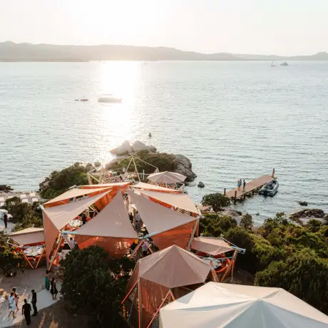 Scenic view of the beachfront dining area at Cone Club, 7Pines Hotels & Resorts, with a beautiful sunset.