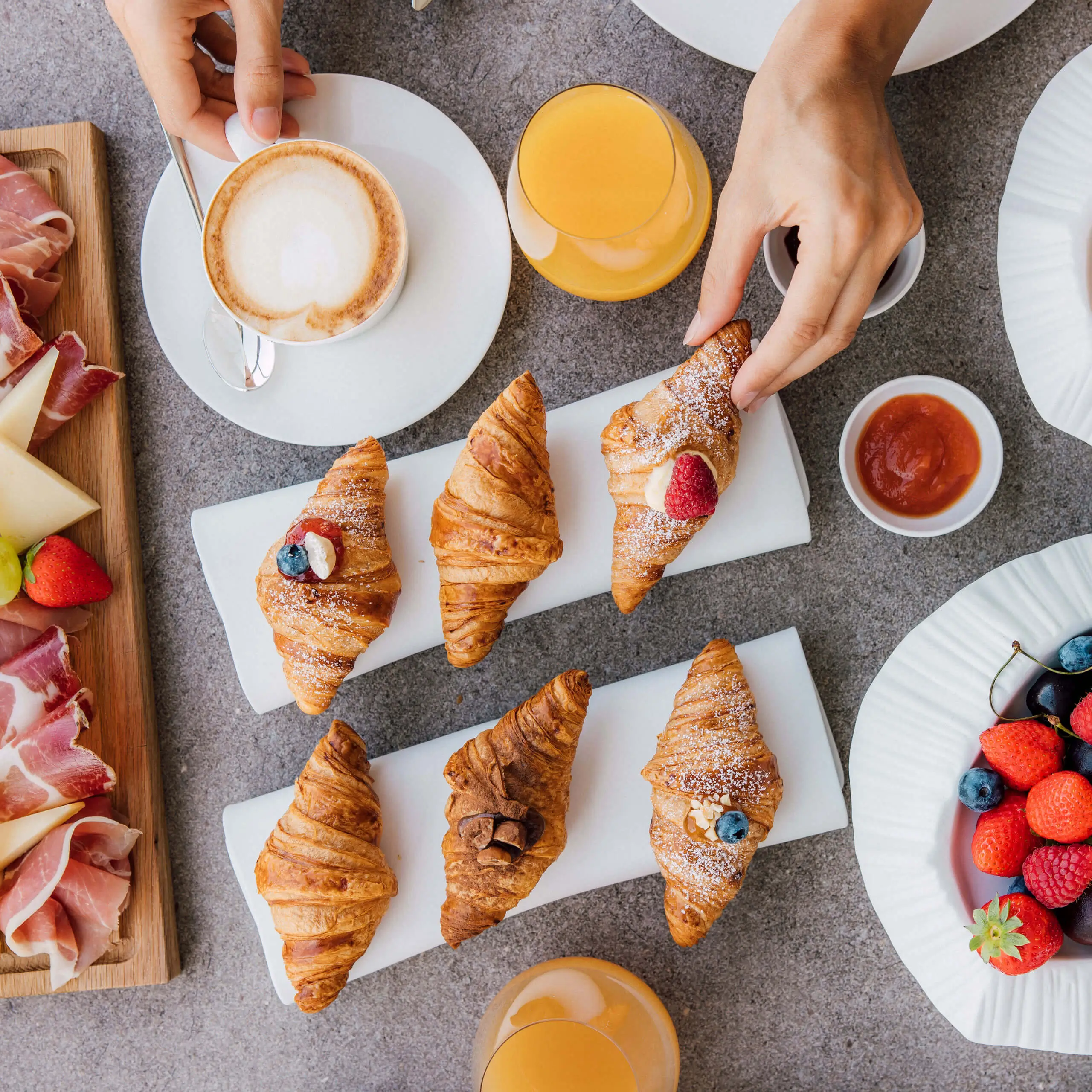 Enjoy a delicious breakfast with croissants, fruits, coffee, and juice at 7Pines Hotels & Resorts.