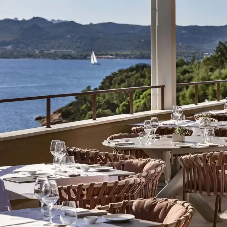 Dining with ocean views at 7Pines Ibiza Resort with exquisite Sardinian wines.